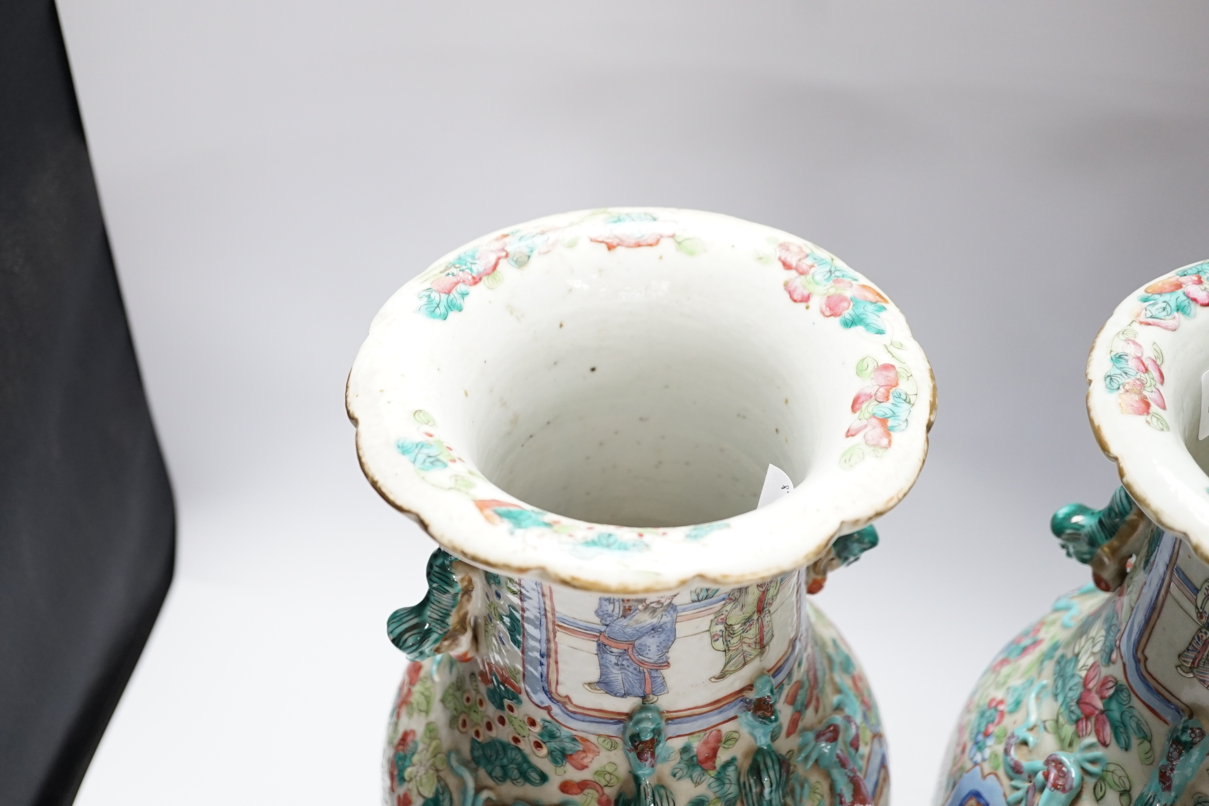 A pair 19th century Chinese famille rose ‘warriors’ baluster vases and stands, 39cm high including stands
